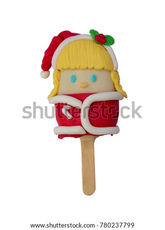 Christmas candies and ice cream decorated as santa girl on white background. New year and Christmas composition
