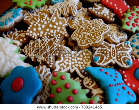 Homemade ginger cookies decorated with colored glaze. Traditional Christmas bakery