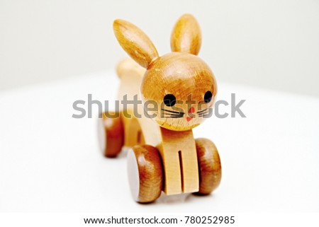 wooden toy rabbit on wheels stock photo