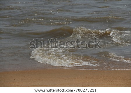 Some little waves roll on the sand