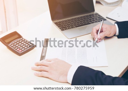 Asian businessman check health insurance documents or various accidents and return value with the calculator While searching for information on law firms, consult the website before making a decision