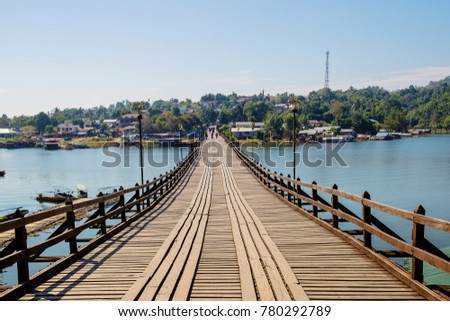 Perspective line from the lower view of long wood bridge. wide image for background, wallpaper, copy space, article and postcard. image for promote tourism. Mon Bridge, Sangkhla Buri, Kanchanaburi.