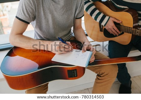 Learning to play the guitar. Extra-curricular lessons for adults. Music education. Masterclass playing the guitar