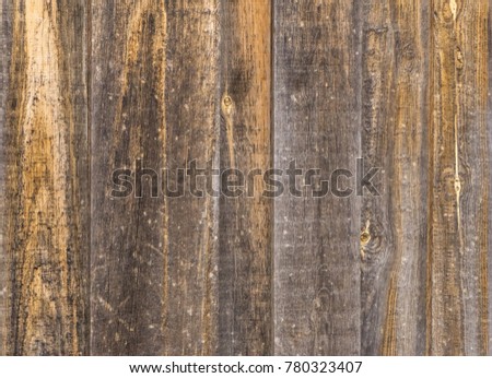Old brown wooden boards background texture, old peeling wooden fence for designers