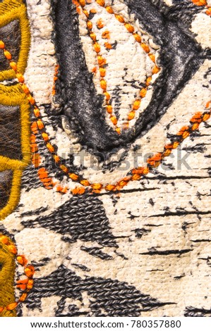 texture of a washed thick knit fabric, with decorative elements, seams and stitching, close-up