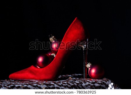 High heel red shoes with Christmas decorations closeup. Children's red shoe filled with sweets and christmas decoration