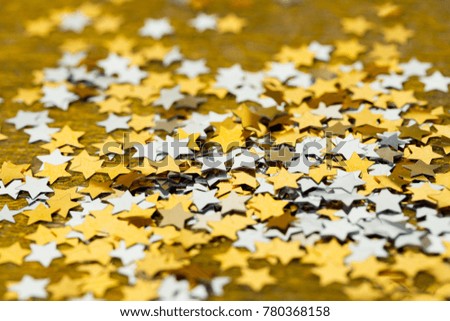 Asterisks shiny Christmas scattered on a gold background