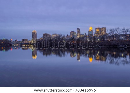 A Wide Angle Long Exposure Shot of Minneapolis Behind Nicolette Island Reflecting in a Calm Mississippi River During an Early Winter Twilight