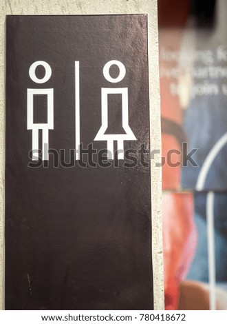 Toilet sign for man and woman on the wall, free space