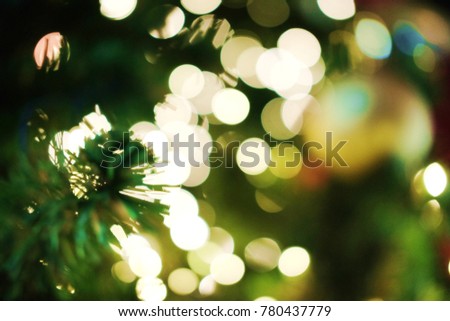 Multicolored light Abstract bokeh background and blurred of Christmas tree decorations on celebrations display in the night.Blinking Garland.Green bokeh Tone.Christmas and holiday concept.