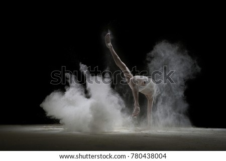 Male gymnast in white dust cloud shot