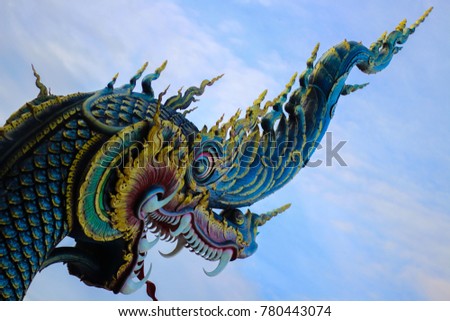 
Blue Naga Statue Located in front of the temple in Thailand. The back is sky