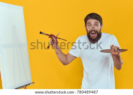 logo, painter with brushes on a yellow background, art                               