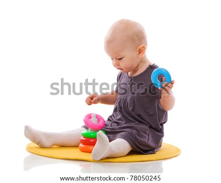 One year Baby playing with toys isolated on white