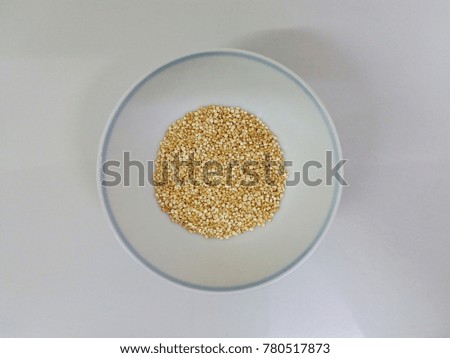 Top view of creamy white Quinoa in white bowl and white background.