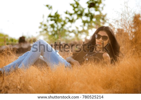 Beautiful girl posing in a field
