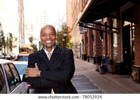 A happy business man on a street in a city