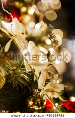
New Year 2020. Christmas beautiful lights bokeh on gold warm background. Defocused Lights on a Tree Background. Christmas tree toys. Golden abstract blinking blurred.
