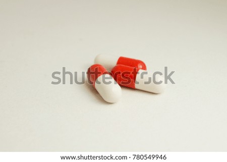 three red and white tablets, isolated