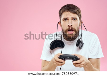 joysticks, a man with a beard playing the console on a pink background, ps4                              