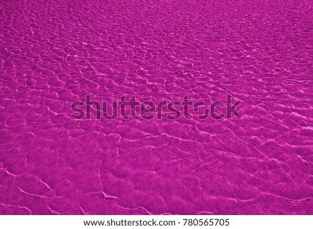 Pink colored transparent pool water