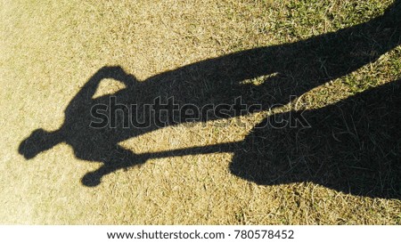 The shadow of a man and his guitar.