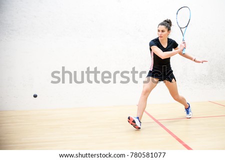 Exercise on the backhand in squash, girl athlete Royalty-Free Stock Photo #780581077