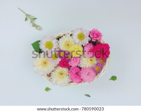 Rose, daisy, many flowers, white, yellow in a basket on a white background. Top view