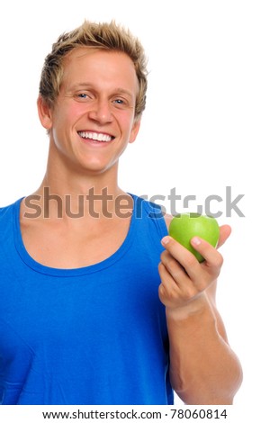 Fit young caucasian man holds a green apple, displaying a healthy lifestyle