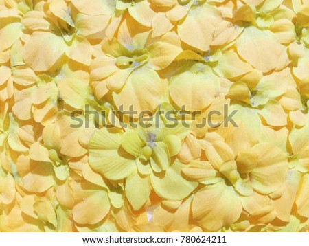 Artificial yellow flowers background