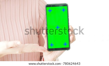 woman take cell phone and show green screen in the home