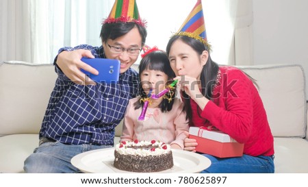 family selfie happily with birthday cake in the home