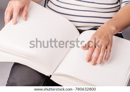 Blind woman read book written in Braille. Close up finger touch to braille Code
