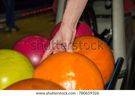Girl holding orange bowling ball