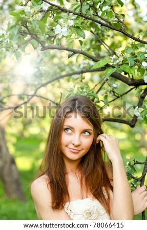 portrait of beautiful young woman relaxing in spring park