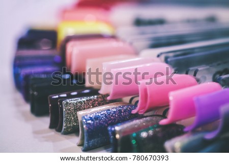 A set of false nails. Examples of nails of dark and pink tones.