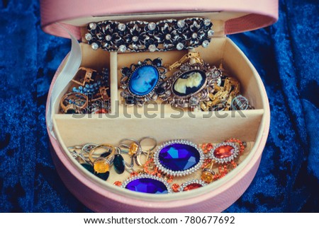 Pink box with vintage jewelry with stones. Concept of femininity, inspiration for gorgeous woman