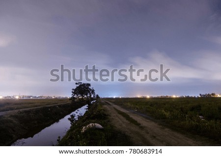 landscape during night at paddy field with old house