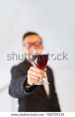 Confident businessmen holding a glass of wine.