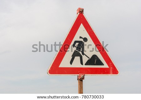 Construction site sign with a female construction worker as a symbol of feminism in professional life