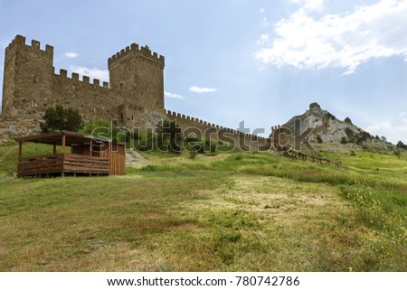 The ruins of the ancient Turkish fortress in Crimea, Sudak. The ruins of the ancient city. The fortress on the cliffs. Ruined wall of ancient medieval fortress. Remains of an ancient fortress Royalty-Free Stock Photo #780742786