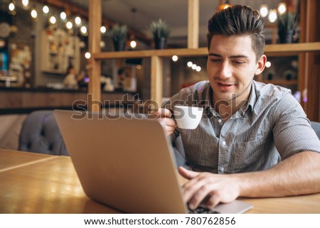 Business man working on laptop in a cafe