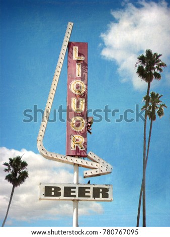 aged neon liquor store sign with palm trees                             