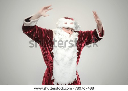 Santa Claus is dancing isolated on gray background.