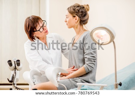 Young woman patient with a senior gynecologist during the consultation in the gynecological office Royalty-Free Stock Photo #780769543