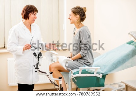 Young woman patient with a senior gynecologist during the consultation in the gynecological office Royalty-Free Stock Photo #780769552