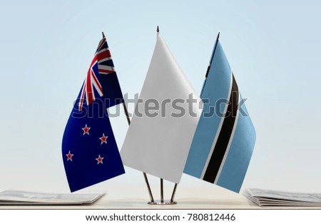 Flags of New Zealand and Botswana with a white flag in the middle