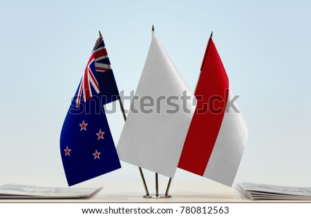 Flags of New Zealand and Monaco with a white flag in the middle