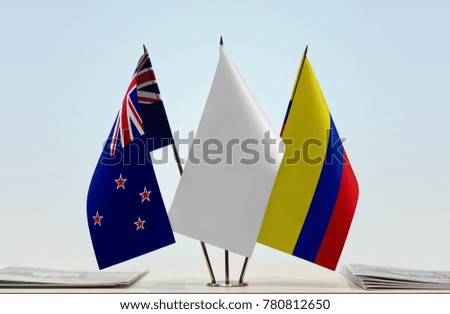 Flags of New Zealand and Colombia with a white flag in the middle