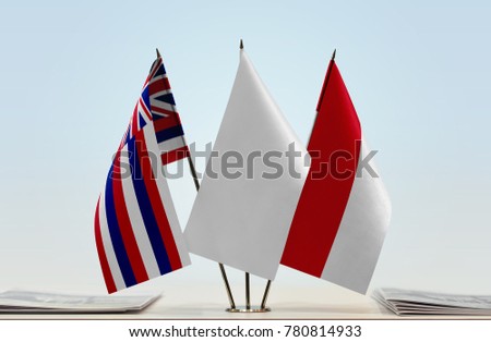 Flags of Hawaii and Monaco with a white flag in the middle